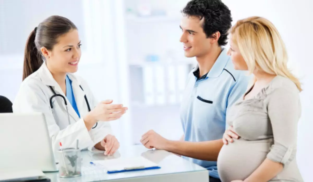 Young cheerful couple visiting a doctor
